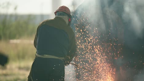 construction torcher cutting through metal pieces