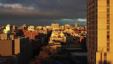 Golden-Hour-drone-rise-over-Harlem-looking-towards-Morningside-Heights-neighborhoods-in-Manhattan,-New-York-City