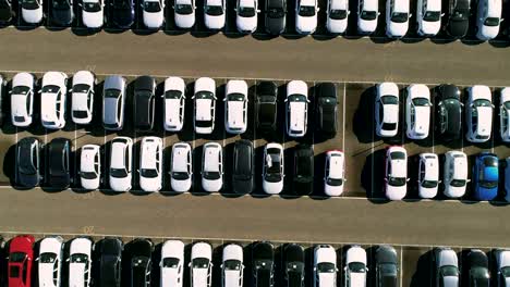 Aerial-footage-of-finished-cars-ready-to-be-shipped-on-huge-distribution-center