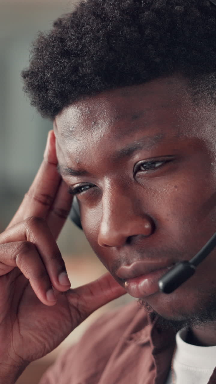 Young African American Man in Headset Concentrating While Working