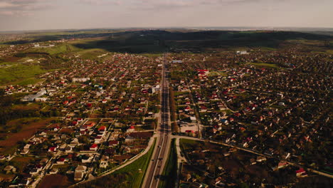 Birds-eye-view-of-highway-with-vehicular-traffic-amidst-countryside-human-settlement