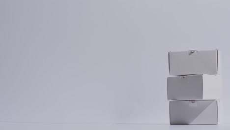 video of stacked cardboard boxes with copy space over white background