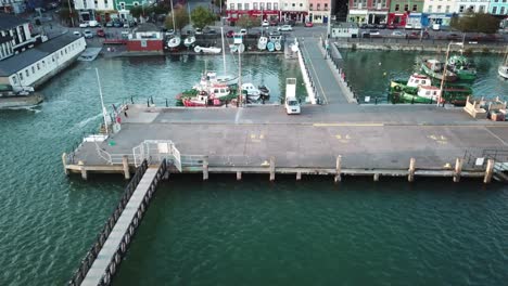 aerial-panning-shot,-Ireland-shore,-pontoon-and-boats-in-a-port