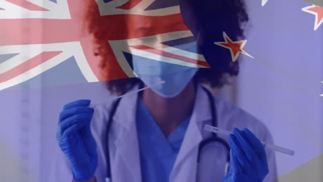 Animation-of-flag-of-australia-over-female-doctor-in-face-mask-and-gloves-inspecting-covid-test-swab