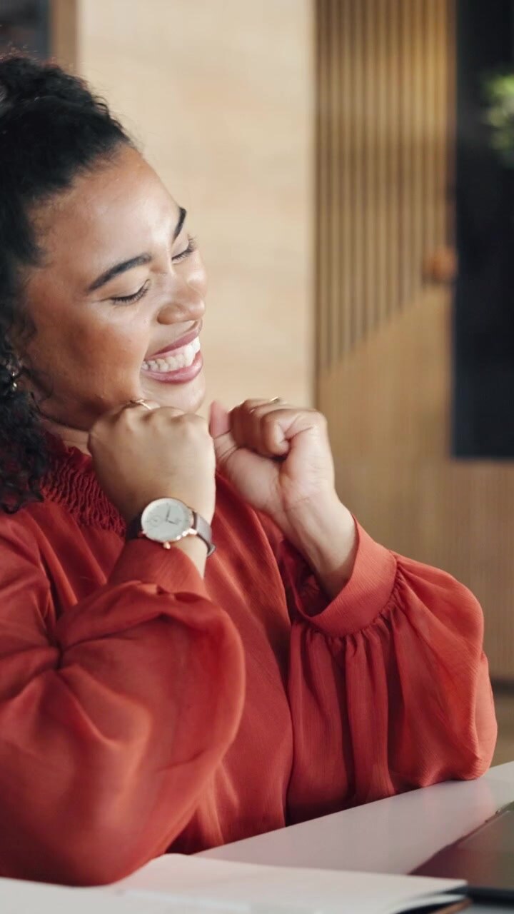 Excited Young Woman Celebrating Success While Working on Laptop