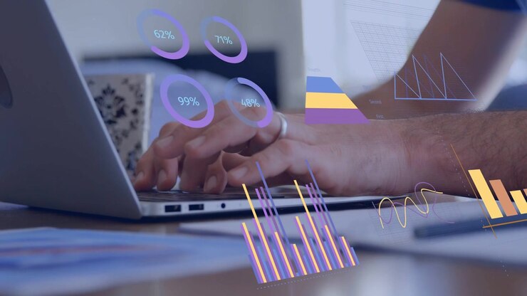 Male professional resting hands then typing, updating animated analytics charts across laptop desk