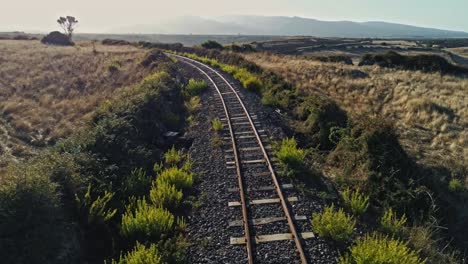 Aerial-drone-over-train-tracks-through-the-countryside