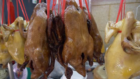 cooked seasoned whole duck chicken at asian street food market for sale