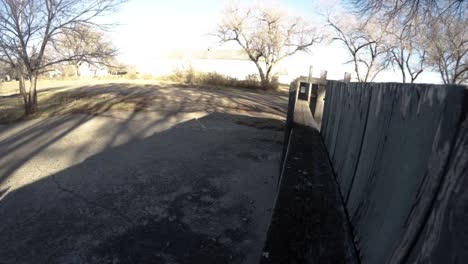 TIME-LAPSE---During-the-day-in-the-front-yard-of-a-house-with-shadows-of-trees-slowly-cross-the-drive-way