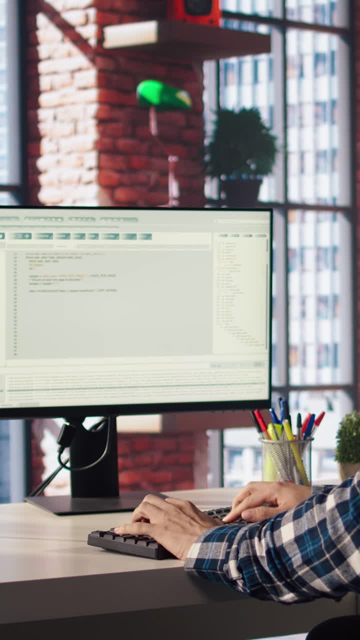 Vertical video Man in home office fixing errors in application using chroma key device and PC