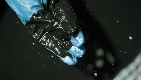oil spill with blue gloves