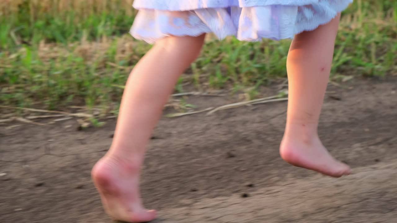 Child Running Barefoot on a Dirt Path