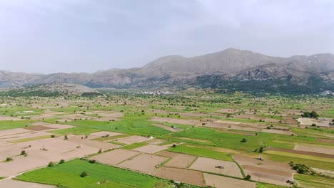 beautiful parallax aerial shot of agriculture fields at lasithi plateau, crete