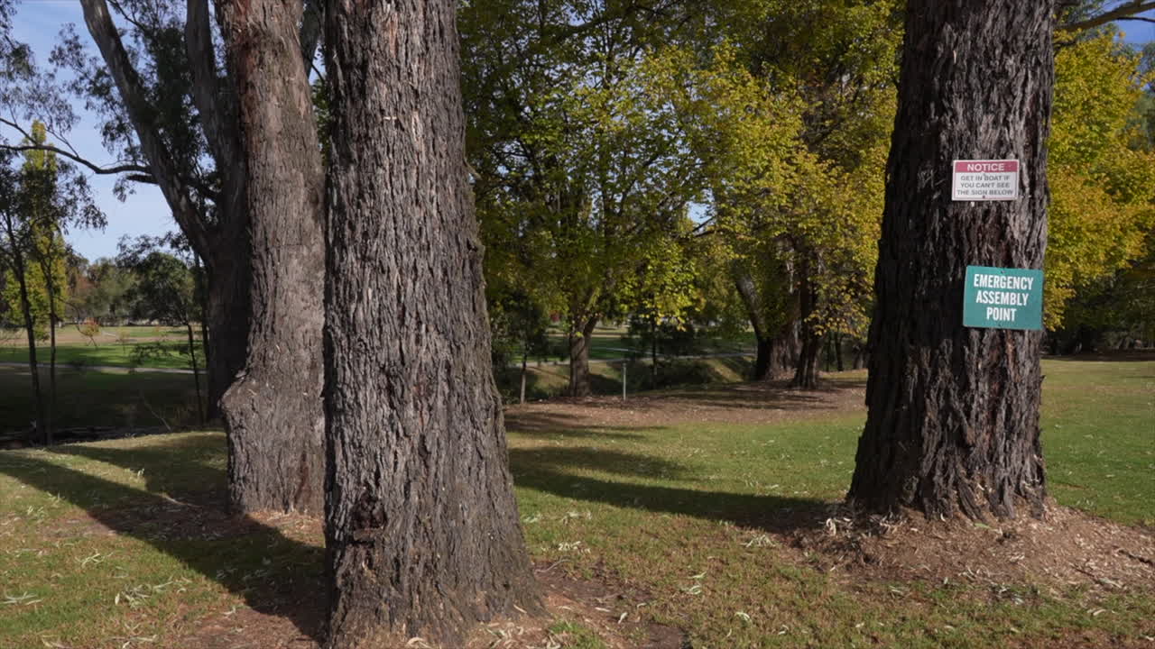 Wide shot Comical warning sign about flood levels around Morley creeks river in Gundagai, New South Wales, Australia