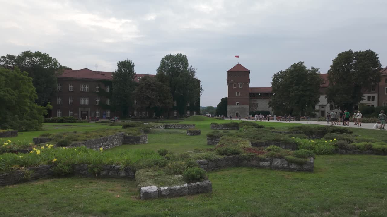 Wawel Castle in Krakow, showing its impressive medieval architecture and historic grounds on overcast day