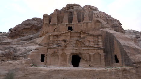 slow pan shot of ancient tempe carved out of sandstone in nabatean city petra