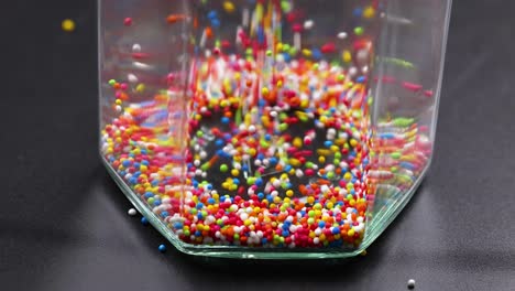 vibrant sprinkles pour into a clear container