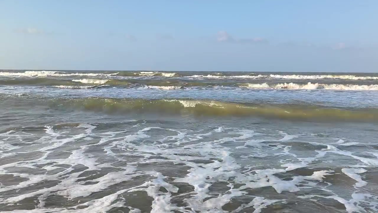 Gentle Ocean Waves Rolling onto a Sandy Beach