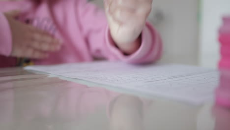 little girl writing with pencil — focused hand detail. clousep shot