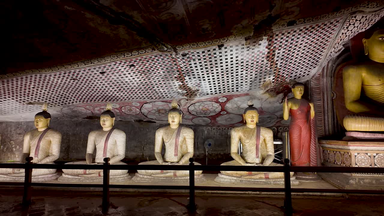A row of intricately carved seated Buddhas inside the historic Dambulla Cave Temple in Sri Lanka, showcasing rich cultural heritage and artistry.