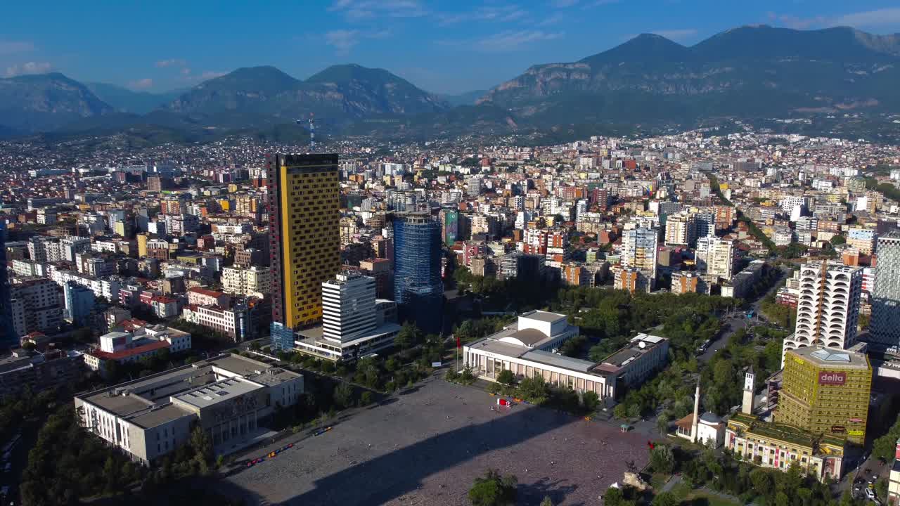 Aerial view overlooking Skanderbeg Main Square and mountains over Tirana city - Albania