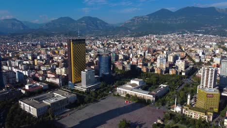 aerial view overlooking skanderbeg main square and mountains over tirana city - albania