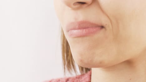 Woman-eating-chocolate-dragee-in-close-up.-Chocolate.