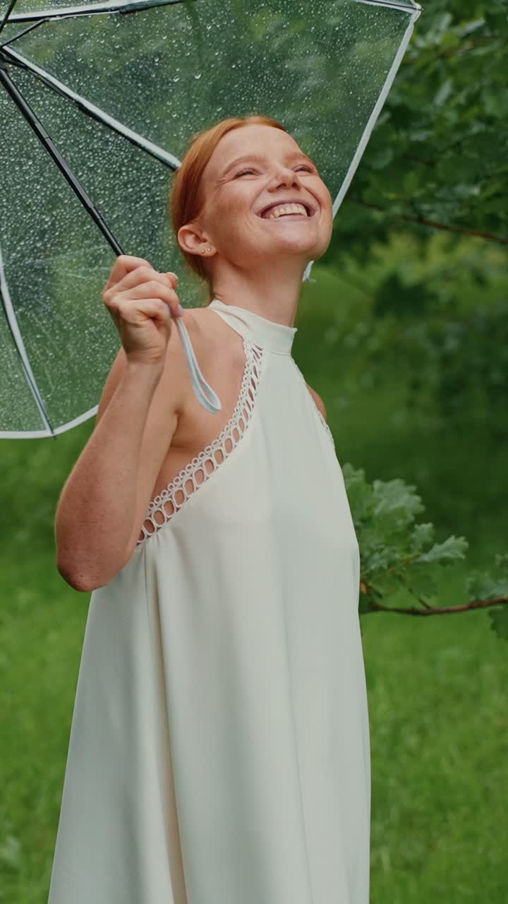 Woman enjoying a rainy day in the park