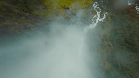 fpv drone dives down a waterfall