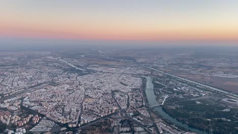 stunning aerial view of seville, , spain, from a jet cockpit taken at sunset, with a beautiful red sky, at 2000m high