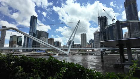 a large city skyline view with high-rises and under construction buildings near a river