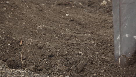 Close-up-of-skid-steer-back-flushing-soil