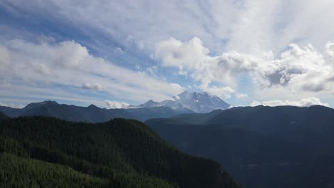 Magnificent-aerial-shot-of-Mount-Rainier-on-a-cloudy-day-flying-sideways