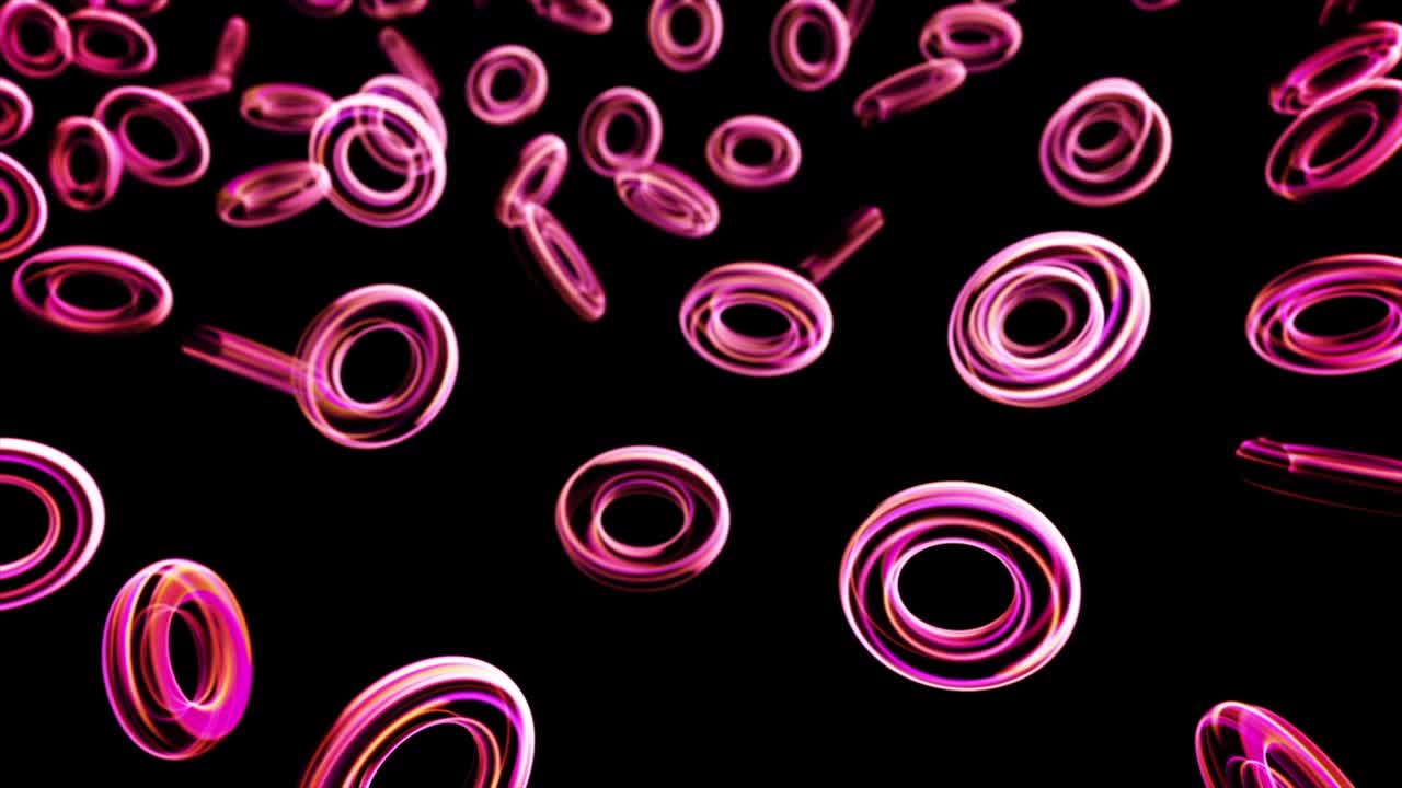 animación abstracta de pequeños anillos de neón coloridos que brillan y flotan sobre el fondo negro. animación. anillos brillantes en la oscuridad