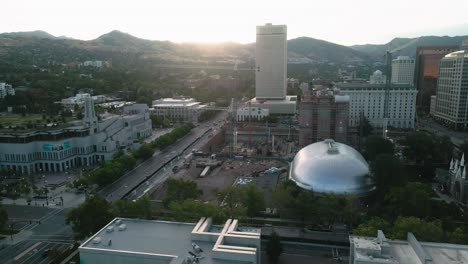 drone orbiting in salt lake city,utah, united states on sunrise at 6am, constraction site having a crane on site 4k aerial clip cinematic