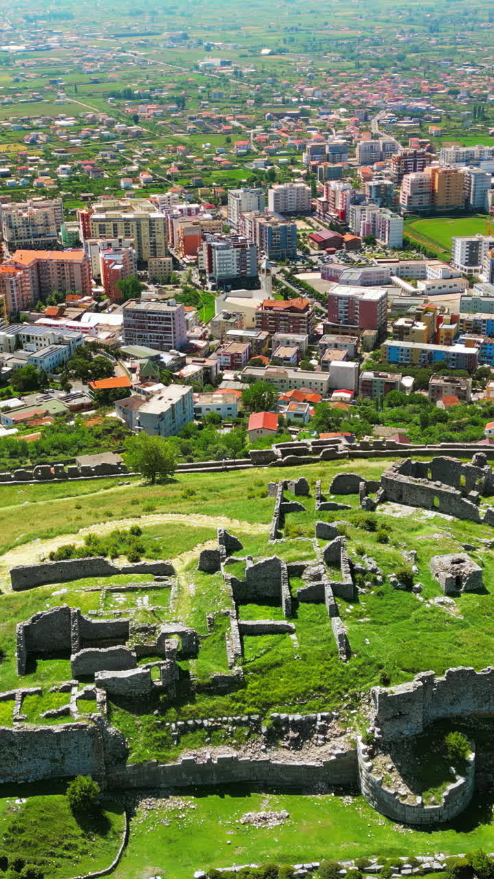 Aerial, drone view of the Lezhe Castle with the city on the background in Lezhe, Albania. Vertical