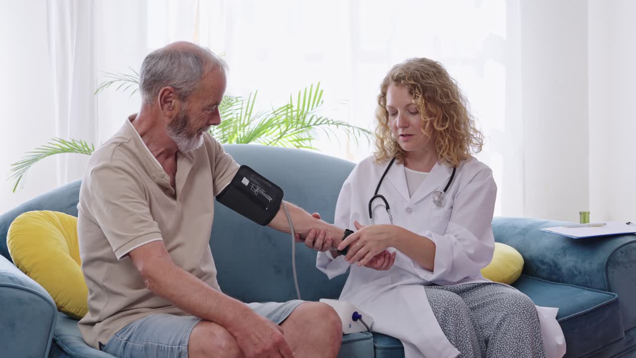 Doctor checking blood pressure of senior patient