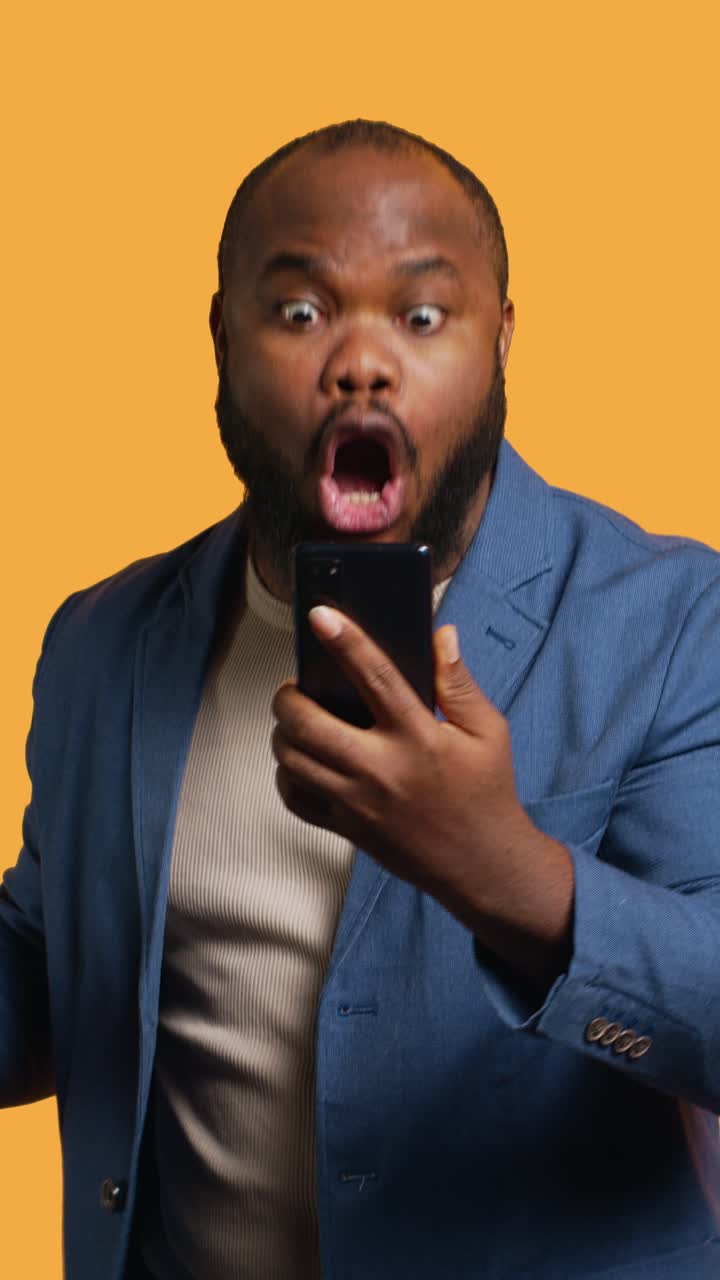 Vertical video Outraged person arguing with mates during chat on phone, studio background