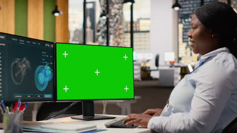 researcher analyzes turbine parts on chroma key pc to maximize sustainability