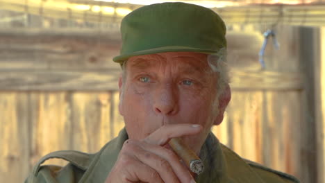 slow motion clip, portrait of senior male smoking a cuban cigar, pensive and thinking