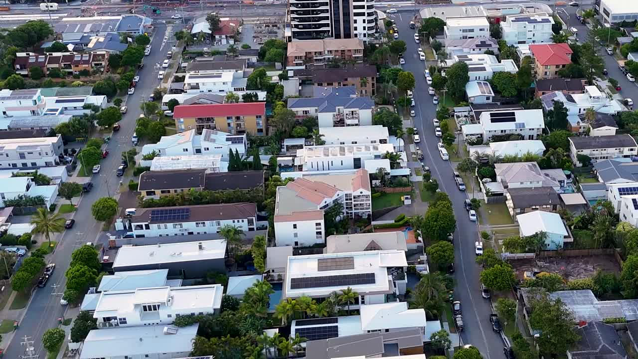High-definition aerial footage showcasing urban streets lined with residential and commercial buildings.