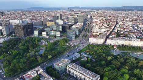 Modern-commercial-office-buildings,-city-park-and-traffic-on-road-in-Vienna-city