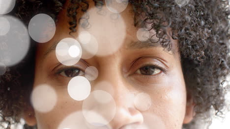 close-up of person''s eyes with bokeh light animation over their face