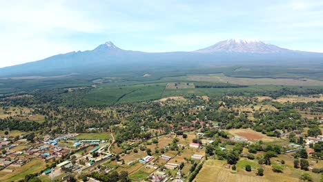 Aerial-drone-view-Open-Air-market-in-the-Loitokitok-town,-Kenya-and-mount-Kilimanjaro--Rural-village-of-Kenya