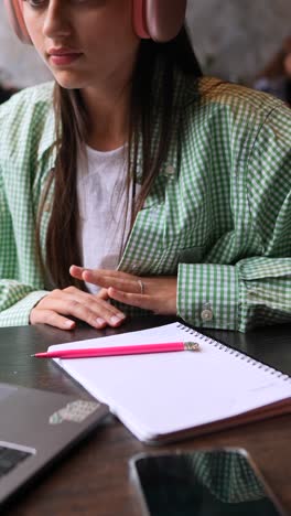 teenage girl studying in a cafe