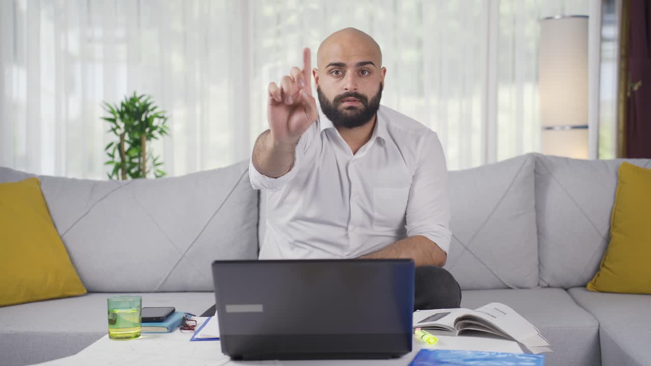 Home office worker man says stop to camera, warns.