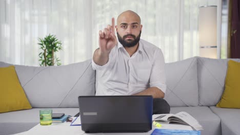 home office worker man says stop to camera, warns.