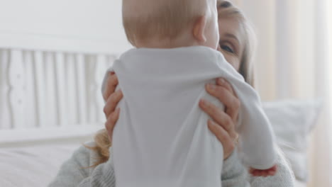 happy mother playing with baby at home smiling enjoying motherhood playfully caring for cute toddler