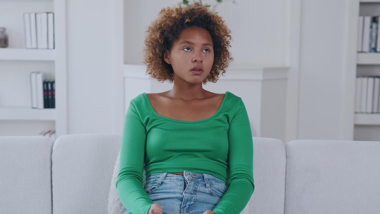 Young attractive african american woman teenager plays video game in phone
