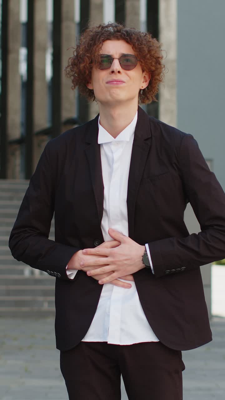 Sick businessman feels stomach pain standing on city street spasms gastritis or poisoning